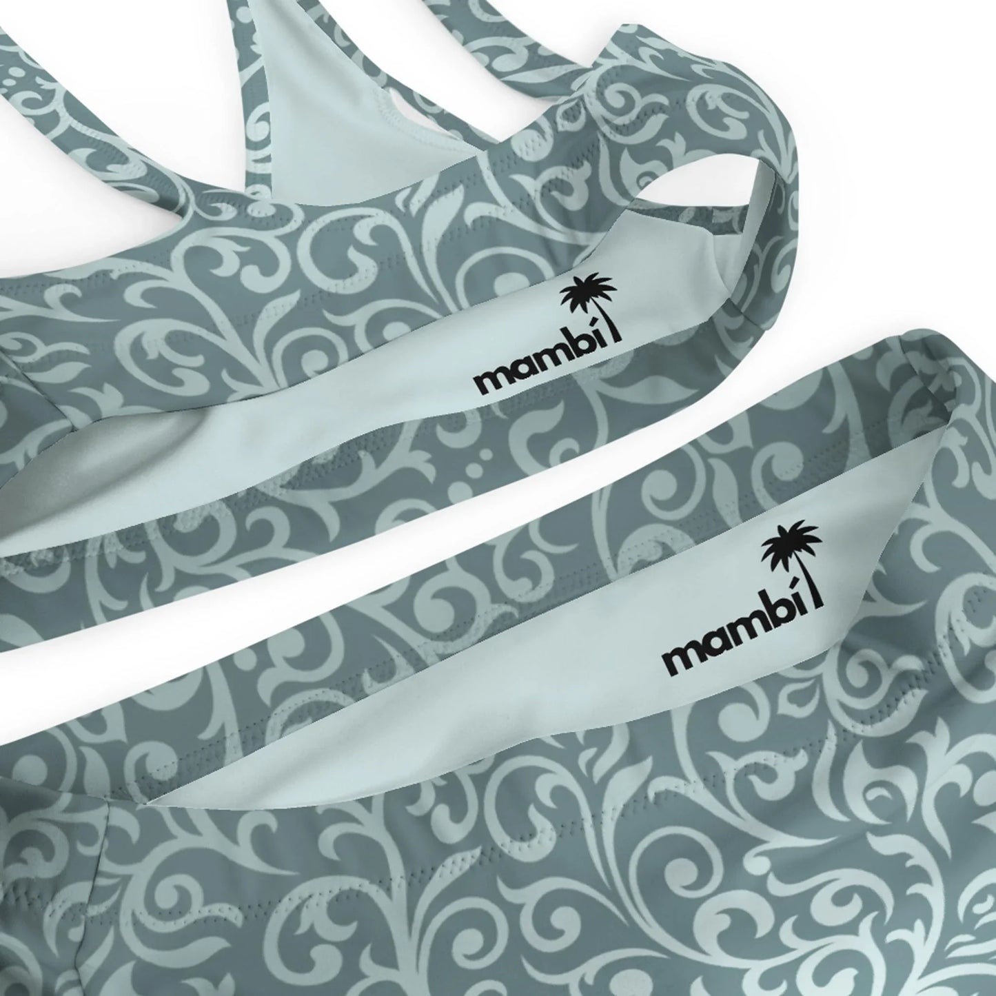 Close-up of two Laurelia High-Waisted Bikini Swimsuits by Printful in gray and white swirling patterns. Each features the mambi logo with a palm tree and provides UPF 50+ protection for safe, stylish sun days.