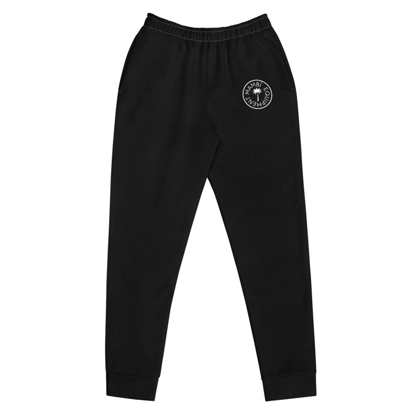 Black sweatpants with an elastic waistband and cuffs, featuring a white circular Mambí logo with text and a small graphic on the left thigh. These pants have a relaxed fit and convenient side pockets.