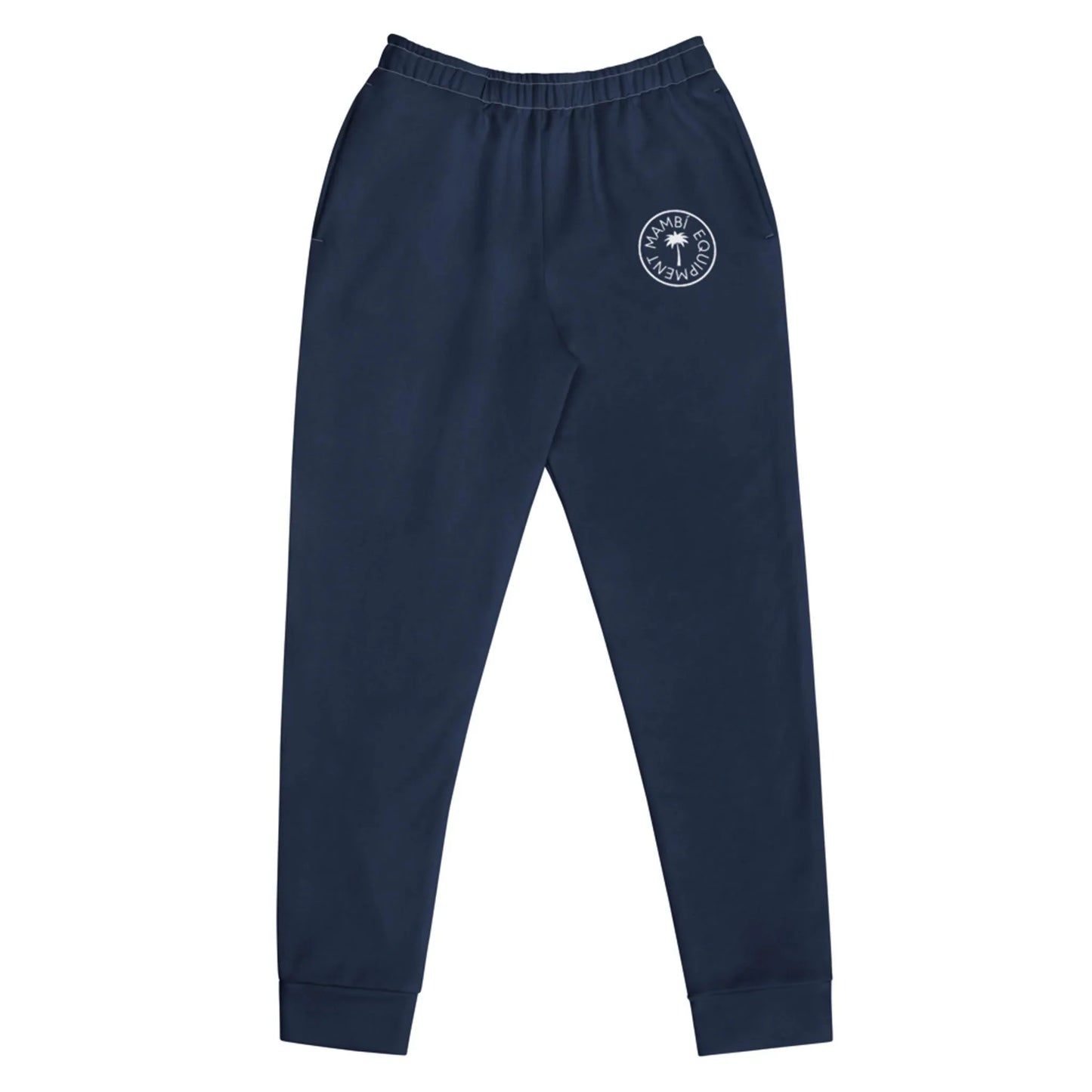Navy blue Mambí sweatpants featuring an elastic waistband, side pockets, and a white circular emblem on the left thigh. These pants offer a tapered fit with cuffs at the ankles.