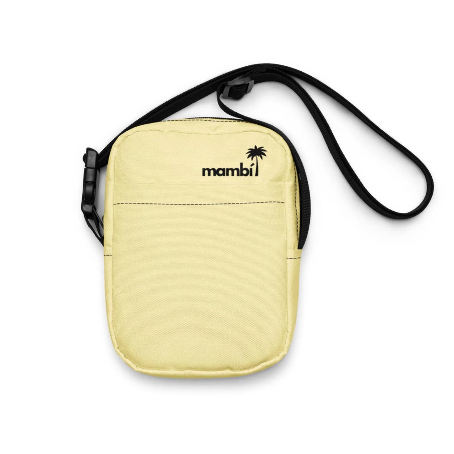 A small, light yellow Mambí shoulder bag with a black adjustable strap, featuring the brand name and a palm tree logo on the front. Its minimalist design includes a convenient front pocket.