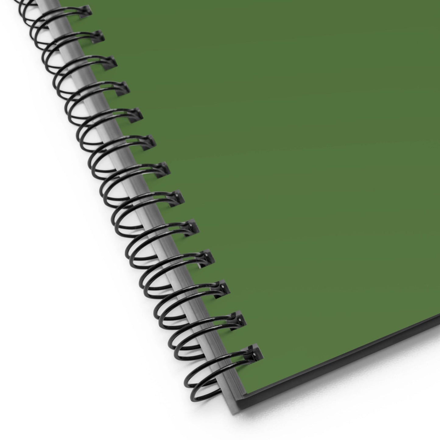 Close-up of the bottom left corner of a custom wire-bound notebook with a solid green cover, featuring black metal coils and the edge of the pages.