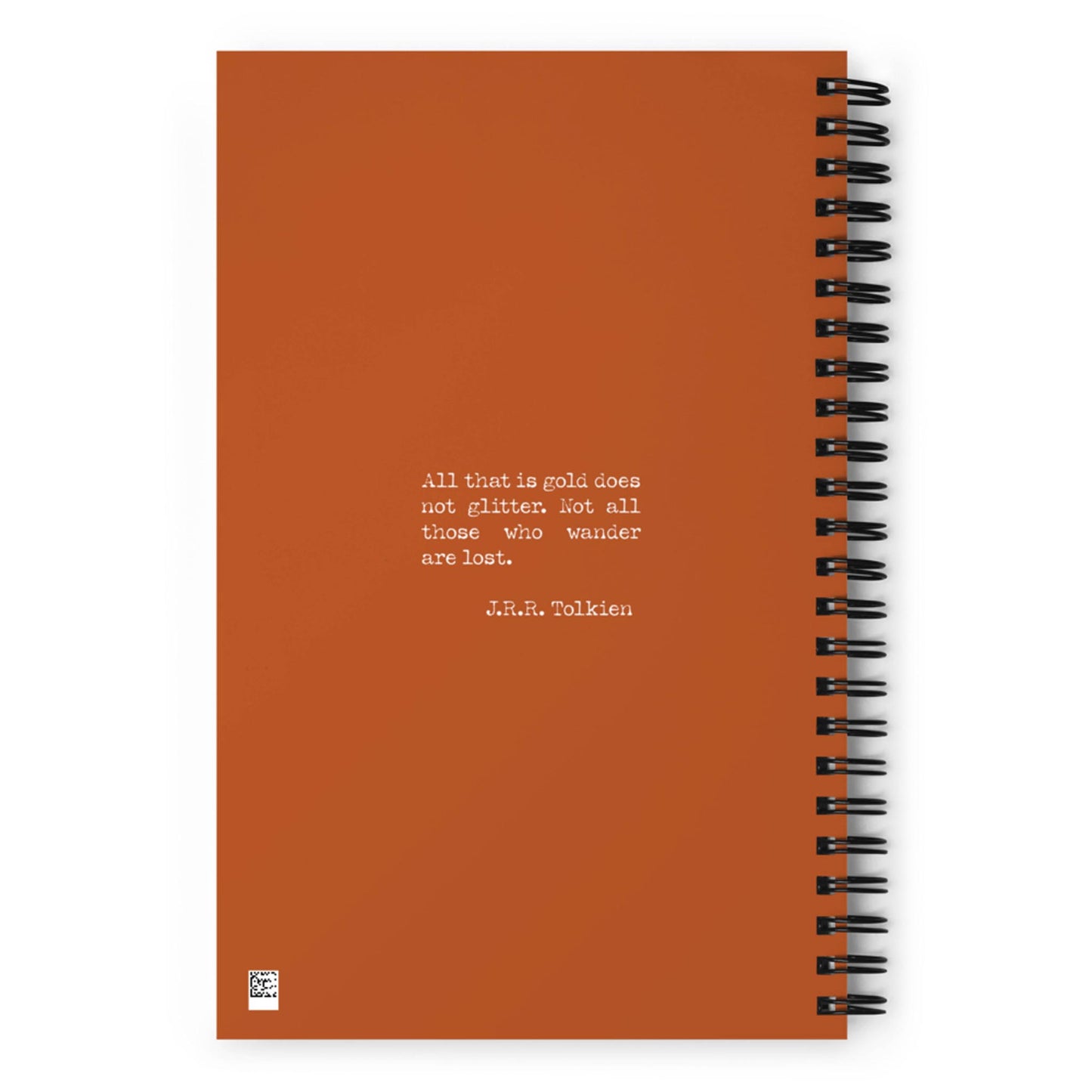 An orange wire-bound notebook featuring a quote in white text: All that is gold does not glitter. Not all those who wander are lost. – J.R.R. Tolkien.