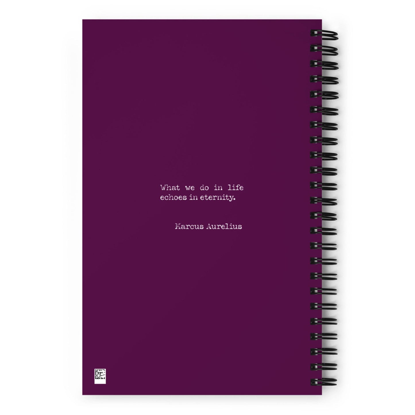 A purple wire-bound notebook with the quote What we do in life echoes in eternity. Marcus Aurelius printed in white text at the center.