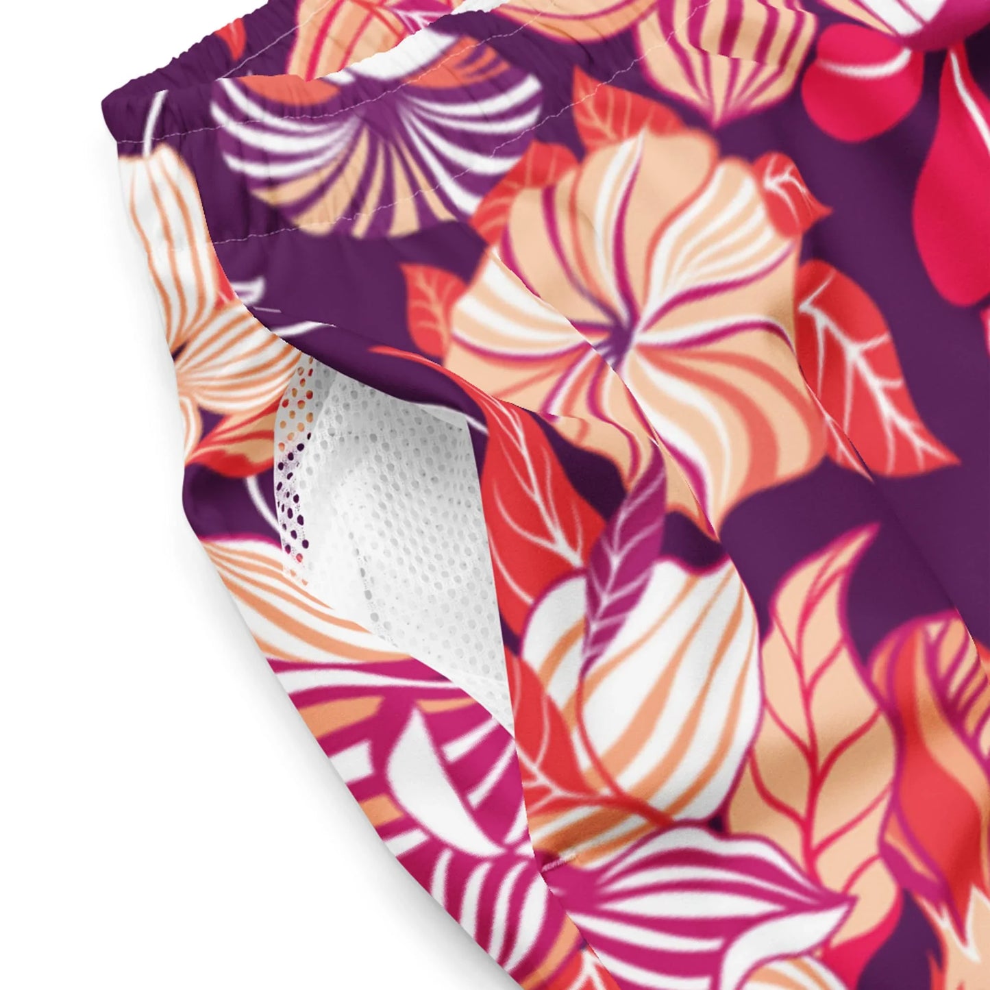 The Mauricio Swim Trunks for men by Printful feature a vibrant floral pattern in purple, orange, pink, and white and are crafted from premium microfiber with an anti-chafe inner liner for comfort.