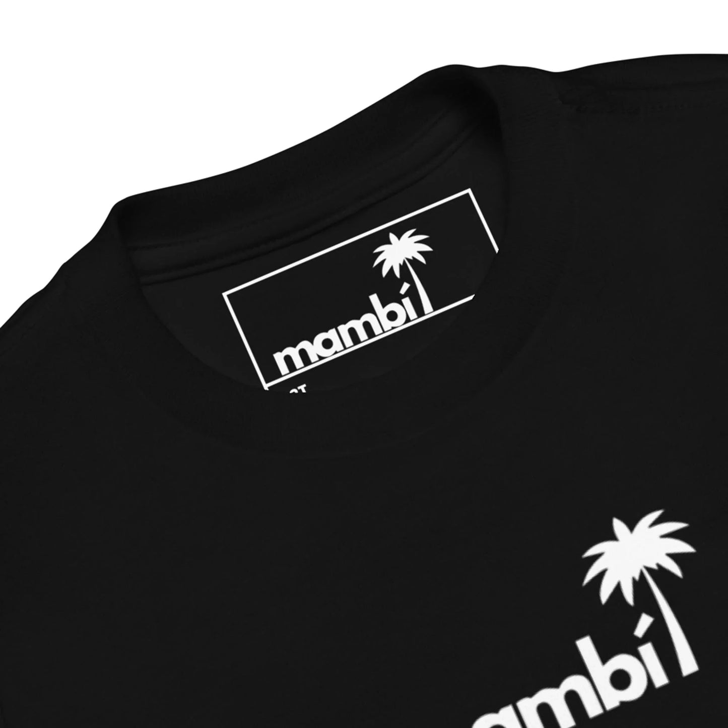 Close-up of a black t-shirt featuring a white palm tree graphic and the word Mambí in bold letters on the chest and inner collar label.