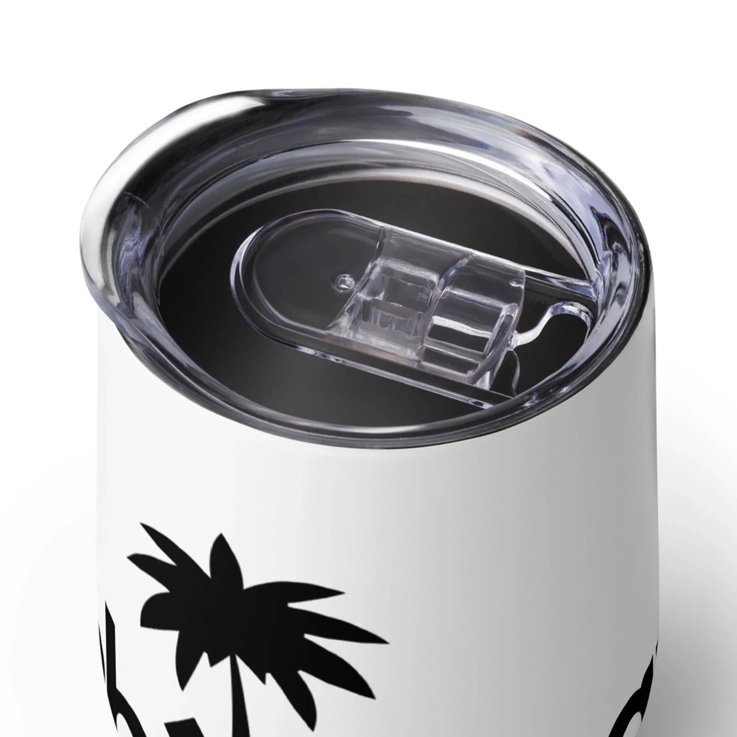 A close-up of a white Mambí travel mug with a clear plastic lid. The mug features a black palm tree design and is filled with a dark beverage.