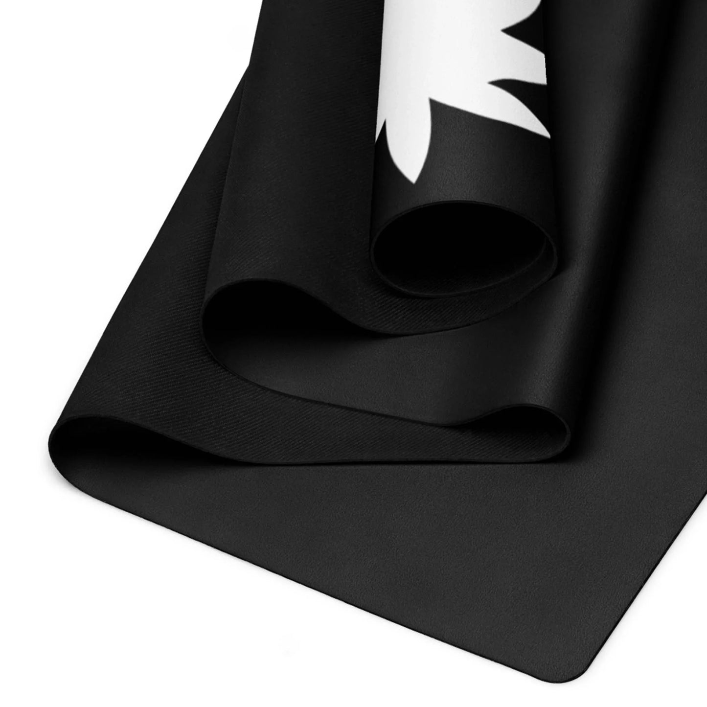 A close-up of two overlapping, rolled black Mambí mats. The upper mat displays a partial white floral or leaf design along the edge, set against a white background.