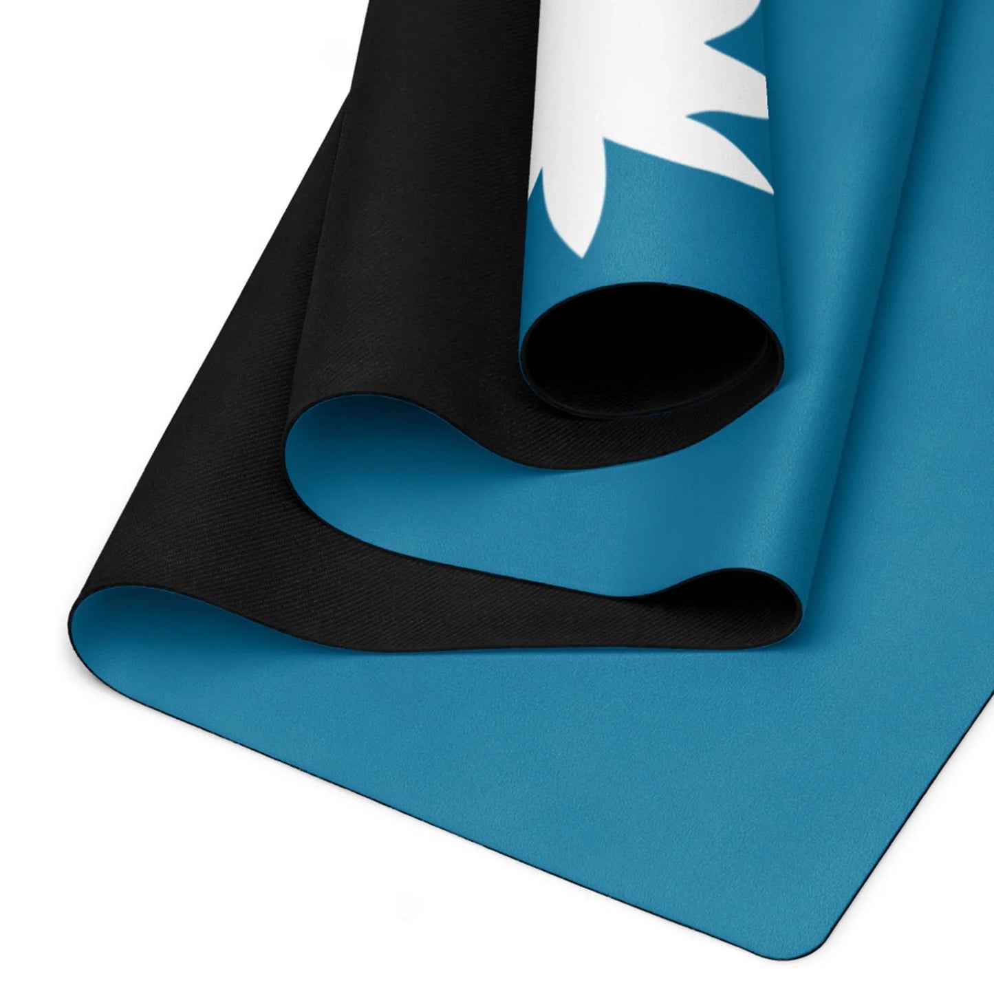 Three rolled-up Mambí yoga mats with a blue underside and black topside; one mat partially shows a white abstract design on its blue edge.