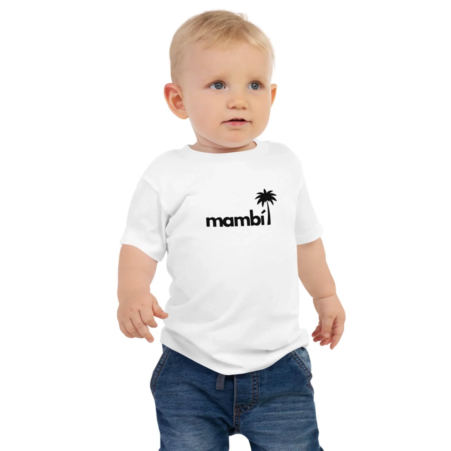 A toddler with short blond hair wears a white t-shirt featuring the word Mambí and a black palm tree graphic, paired with blue jeans, standing against a plain white background.