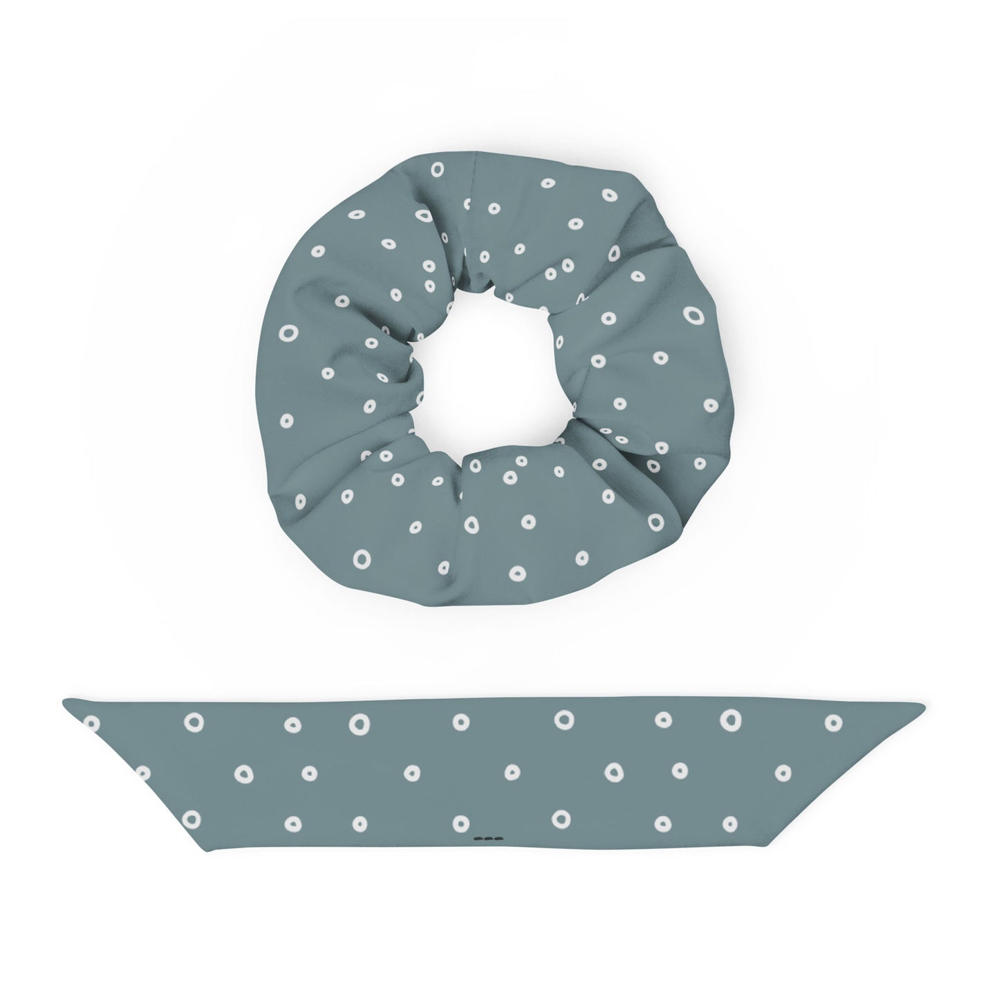 A large, teal blue recycled polyester scrunchie and a matching headband are displayed on a white background, both featuring a pattern of evenly spaced white polka dots. This stylish hair accessory set adds a playful touch to any look.