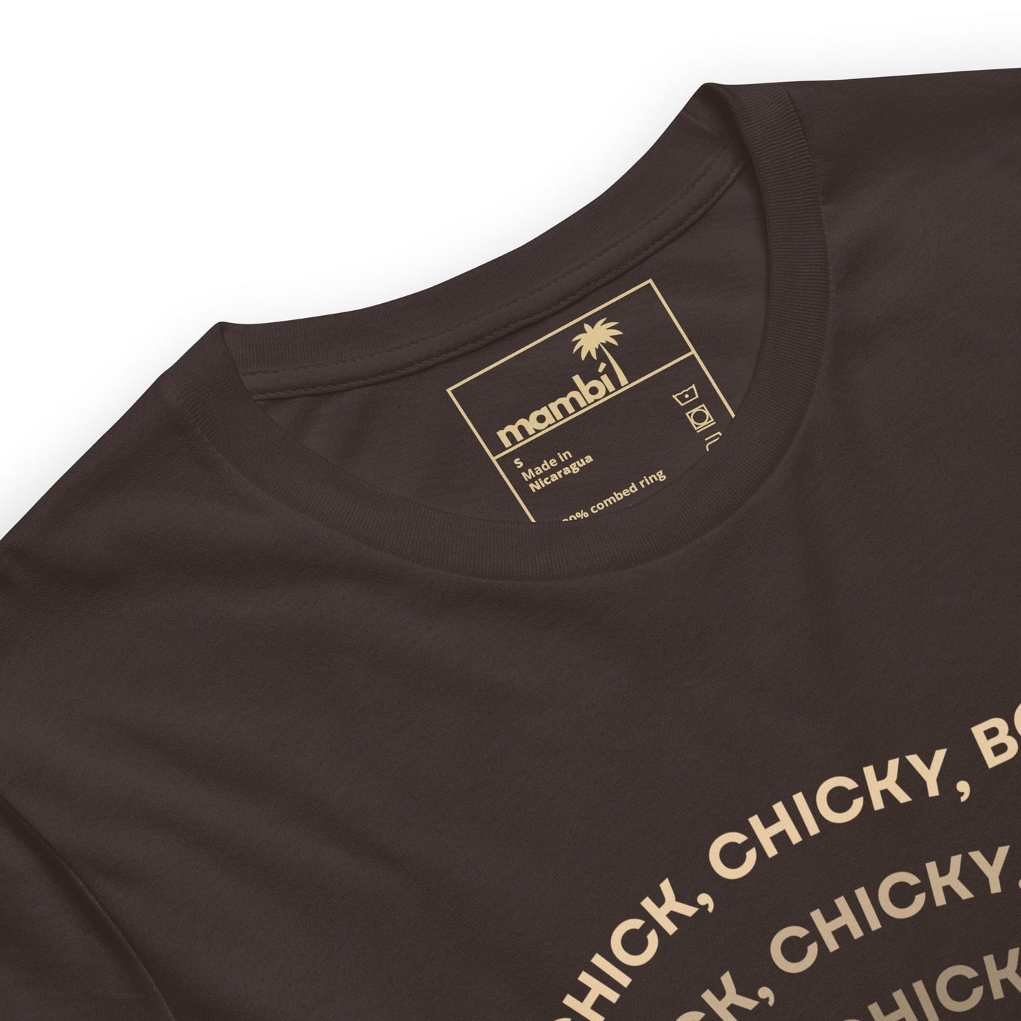A close-up of a brown fitted shirt made from comfortable cotton, featuring a palm tree logo and the brand name mambi on the inside collar tag. Part of a printed text in beige letters appears on the front, showcasing stylish graphic tees.