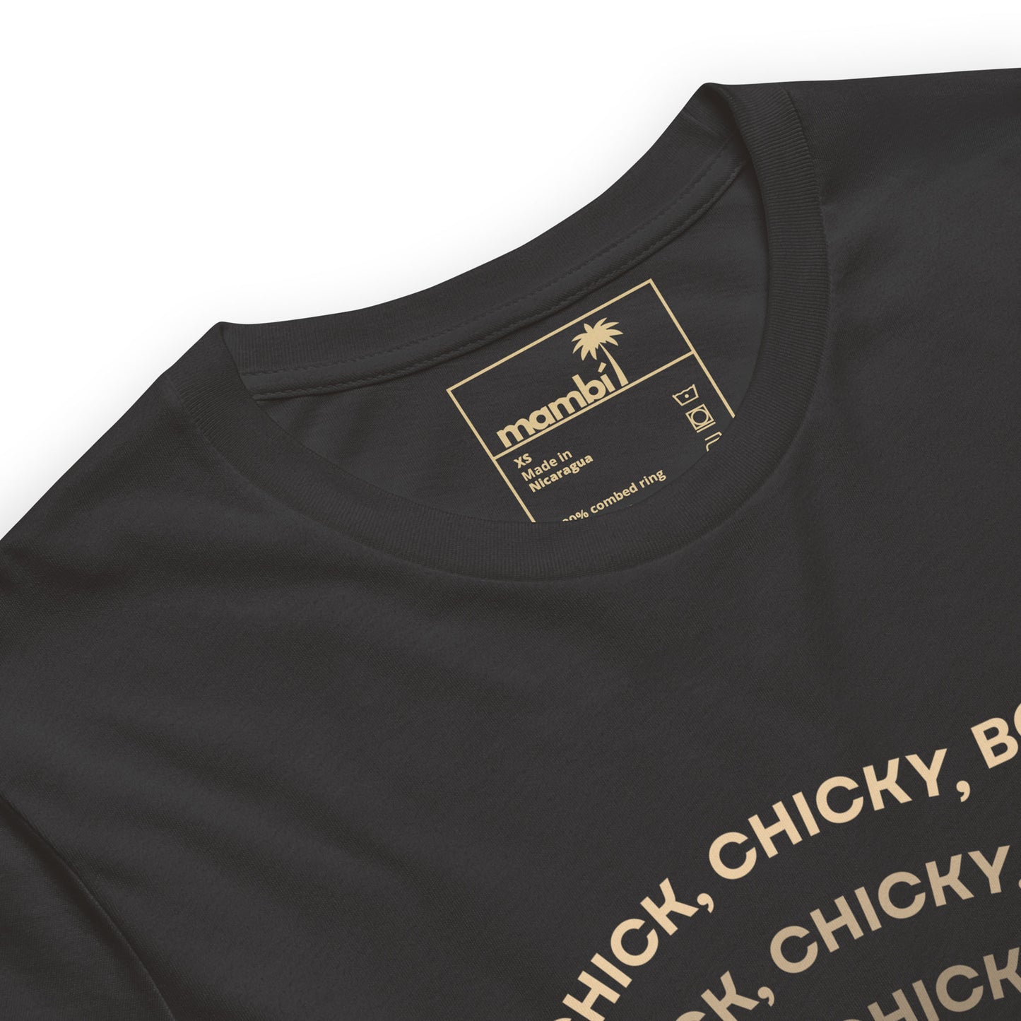 Close-up of a black comfortable cotton t-shirt with a visible gold mambi label inside the collar and the top part of gold text printed on the front. A palm tree icon appears above the label.