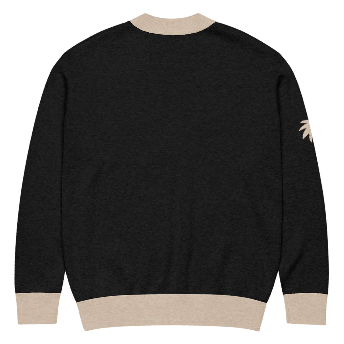 A black two-tone cardigan with beige cuffs, collar, and waistband. There is a small beige palm tree design on the right sleeve near the shoulder. The jacquard knit cardigan is shown from the back.