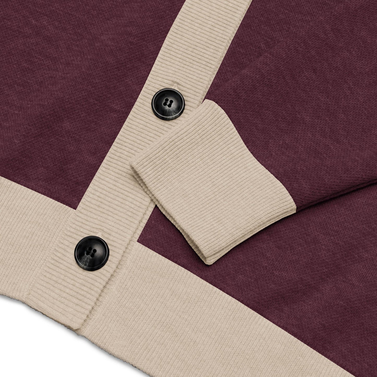 Close-up of a maroon cardigan with ribbed beige trim, featuring two large black buttons and a folded sleeve—this unisex sweater is crafted from a lightweight knit for comfort and versatility.