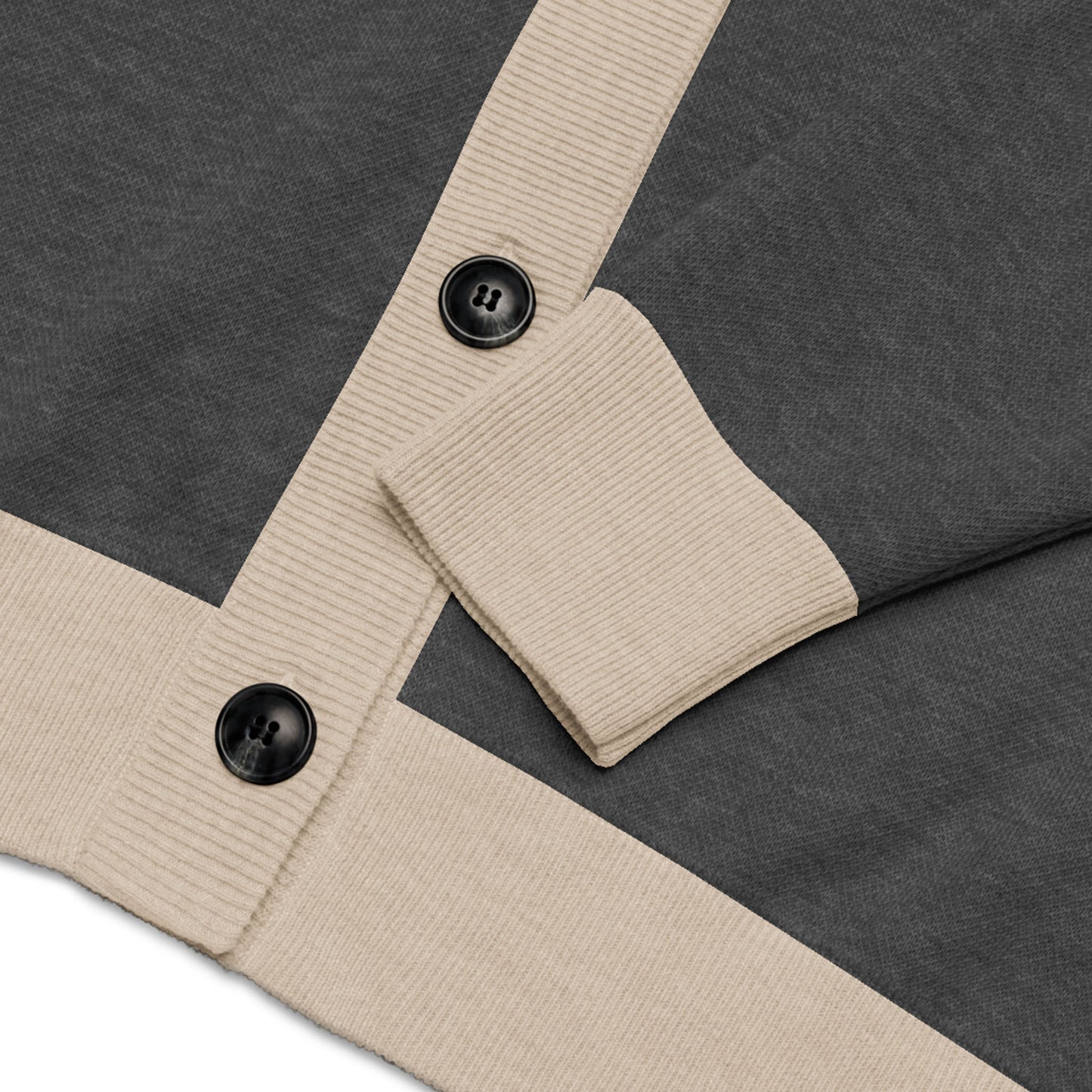 Close-up of a grey two-tone cardigan with beige ribbed cuffs and hem, featuring two large black buttons.
