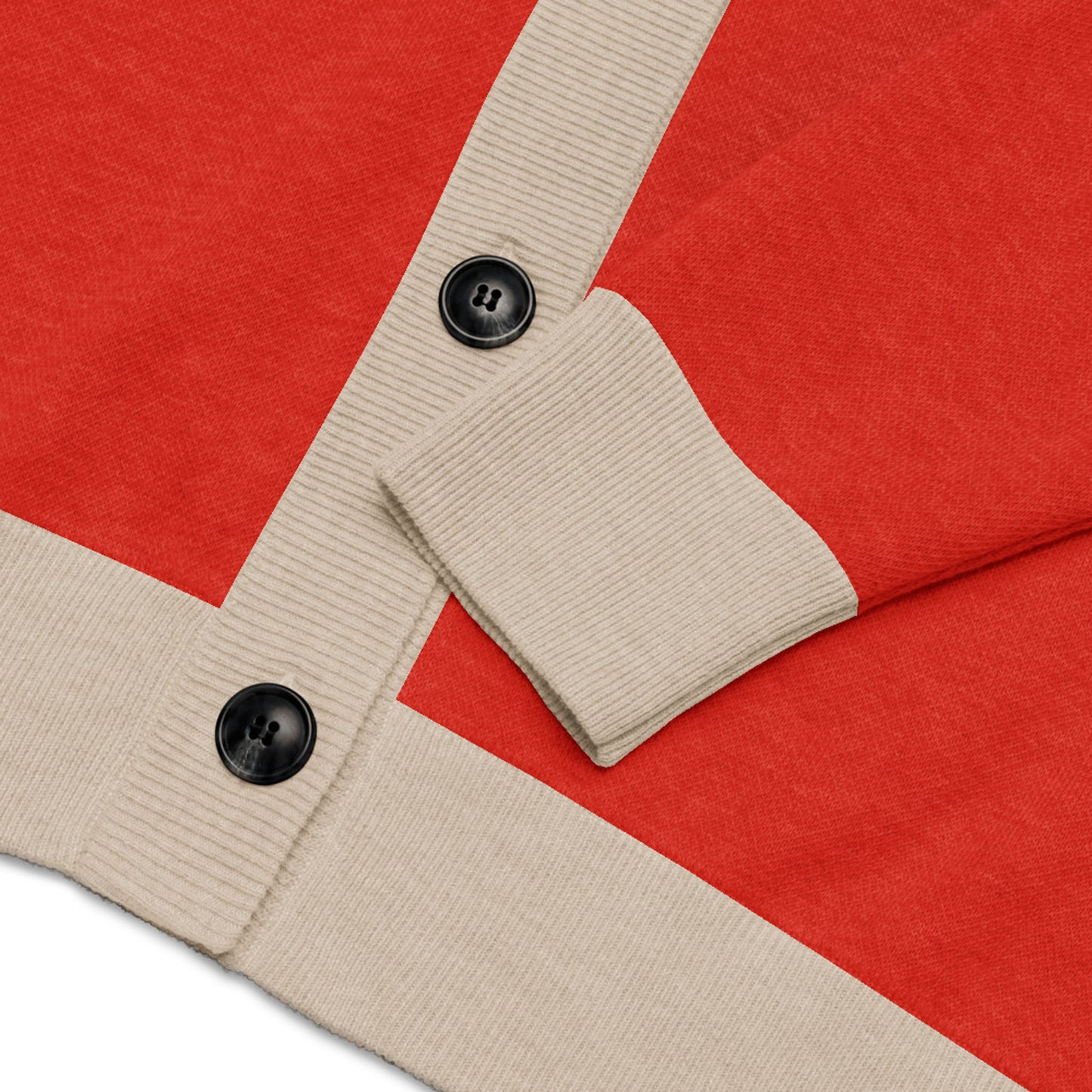 A close-up of a two-tone cardigan with red body and beige ribbed cuffs and button placket, featuring two black buttons.