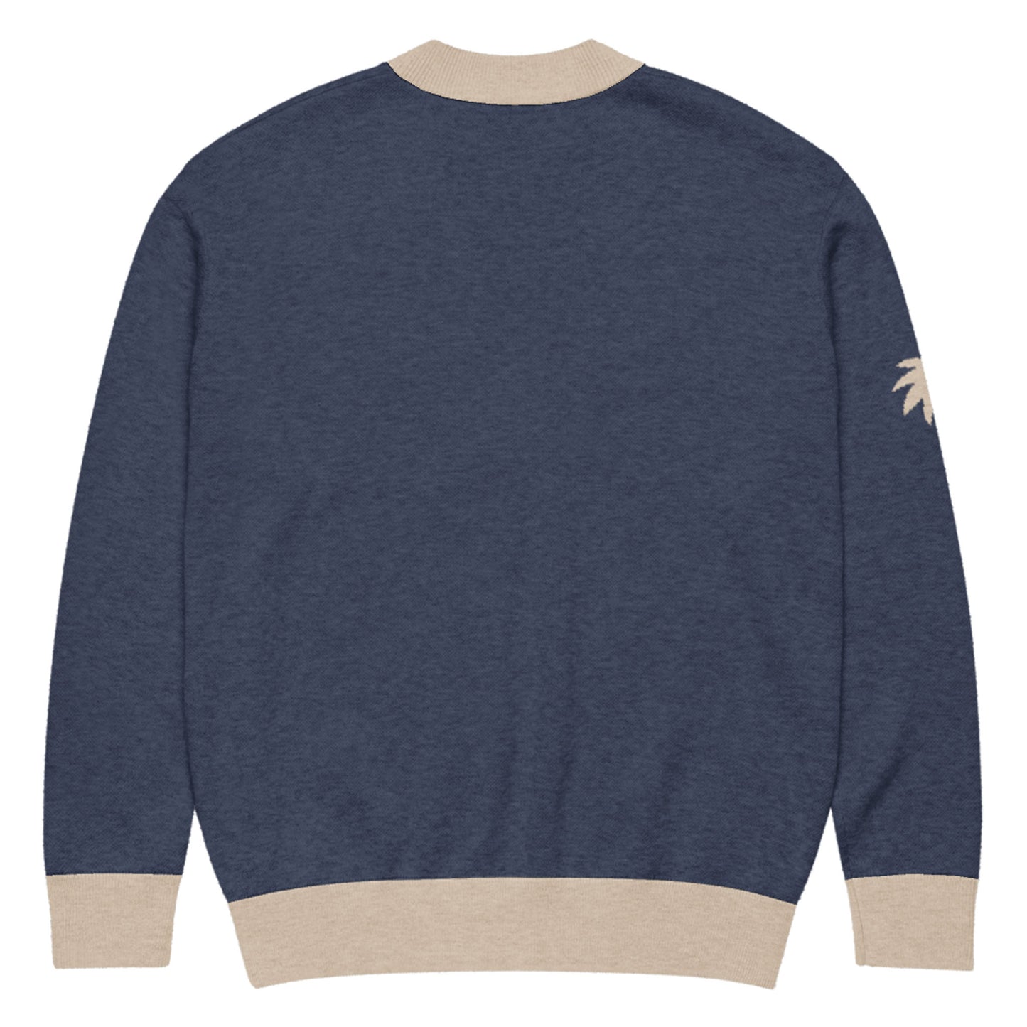 A navy blue jacquard knit sweater with beige ribbed cuffs, collar, and waistband. There is a small beige palm tree graphic on the left sleeve near the shoulder. The soft cardigan is shown from the back.