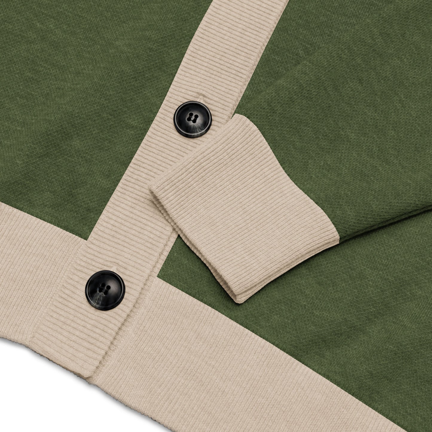 Close-up of a two-tone cardigan with green jacquard knit, beige ribbed trim, and black buttons. The sleeve is neatly folded over the button placket, highlighting the contrasting textures and colors of this unisex cardigan.