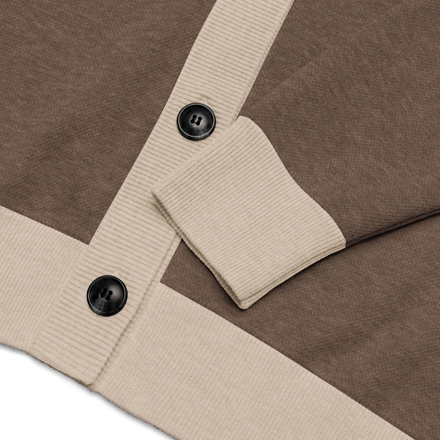Close-up of a two-tone cardigan with beige ribbed cuffs and trim, featuring two large black buttons on the front placket. The sleeve is neatly folded across the body of this stylish unisex cardigan.