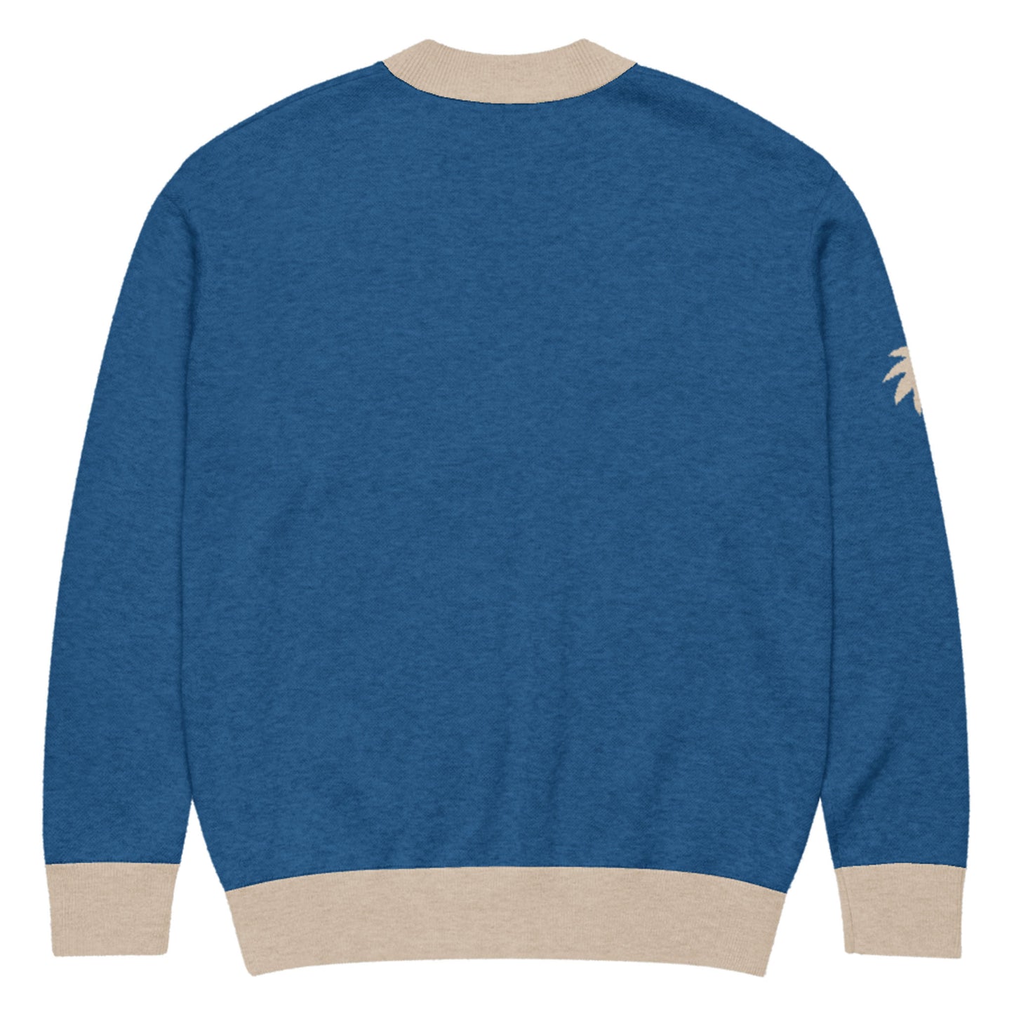 Blue jacquard knit sweater with beige cuffs, neckline, and hem. The back is plain, and there is a small palm tree graphic on the right sleeve near the shoulder. A soft cardigan for a unisex look.