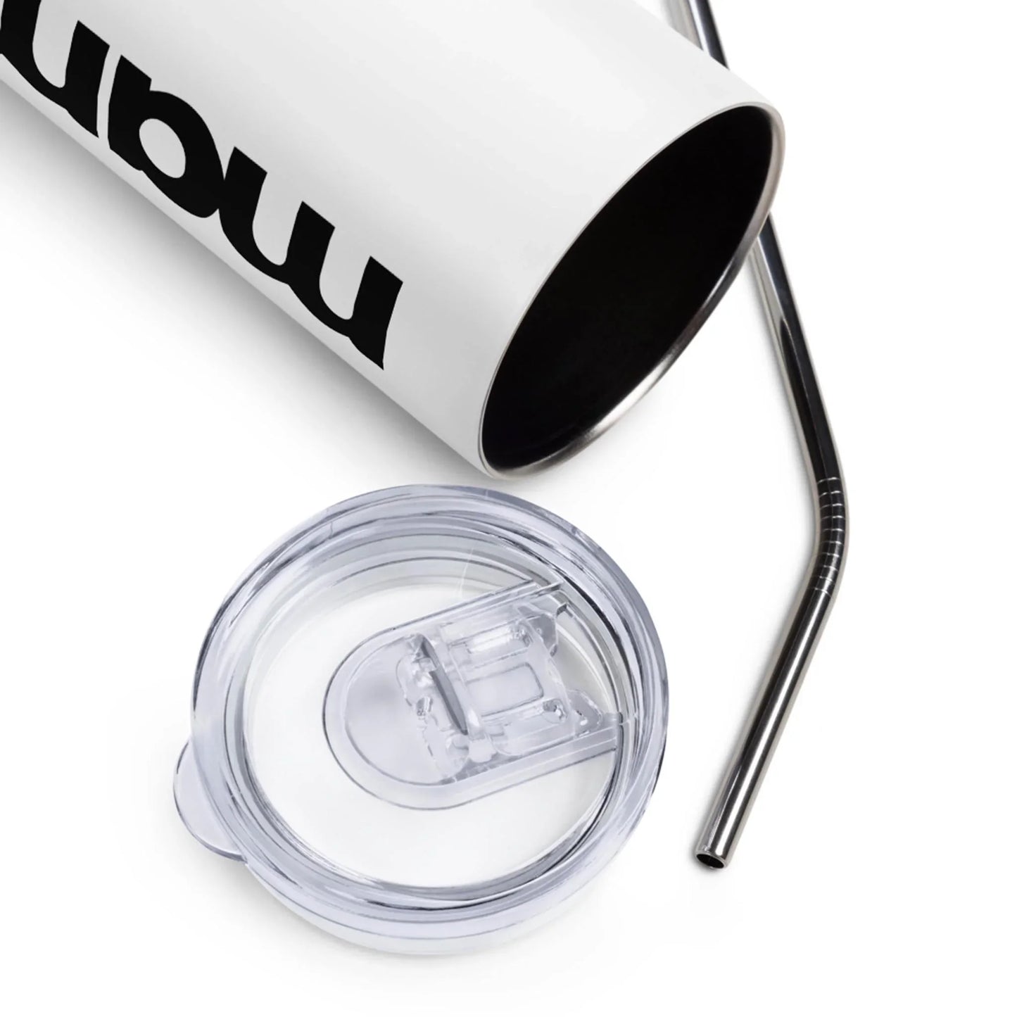 A white Mambí tumbler with bold black text, shown with its clear plastic lid and a metal straw placed beside it on a white surface.