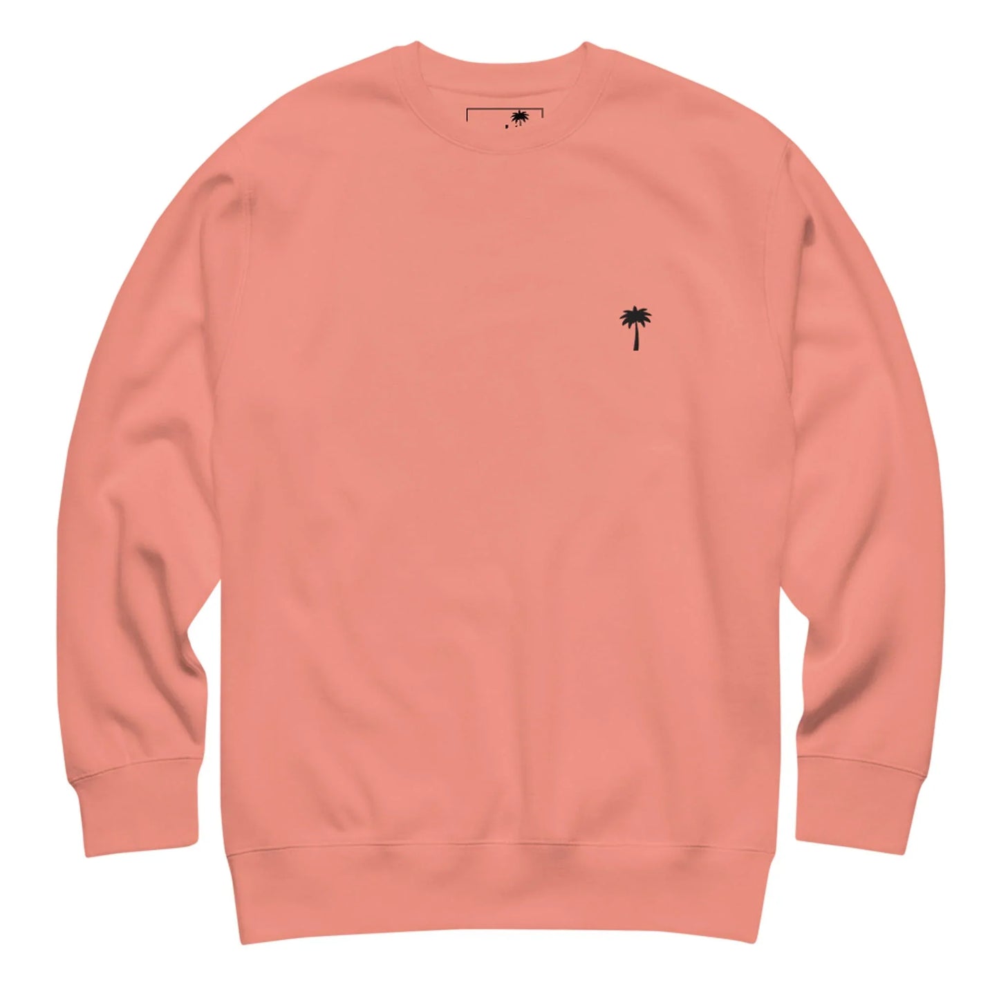 A plain, light pink Mambí sweatshirt featuring a small, simple black palm tree graphic on the left chest area. The sweatshirt has a crew neckline and long sleeves.