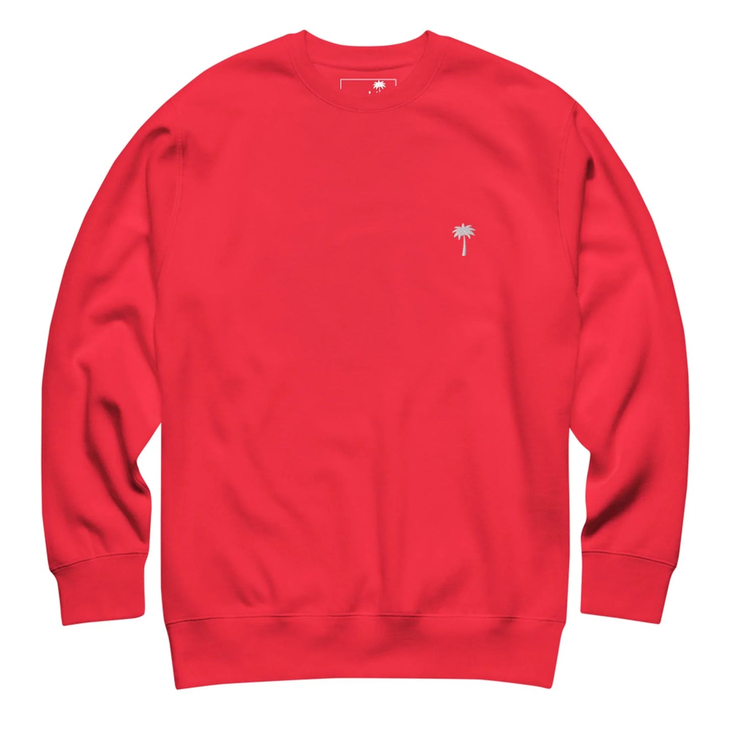 Bright red crewneck sweatshirt with long sleeves, featuring a small embroidered palm tree design and subtle Mambí detail on the left chest. The sweatshirt is laid flat on a white background.