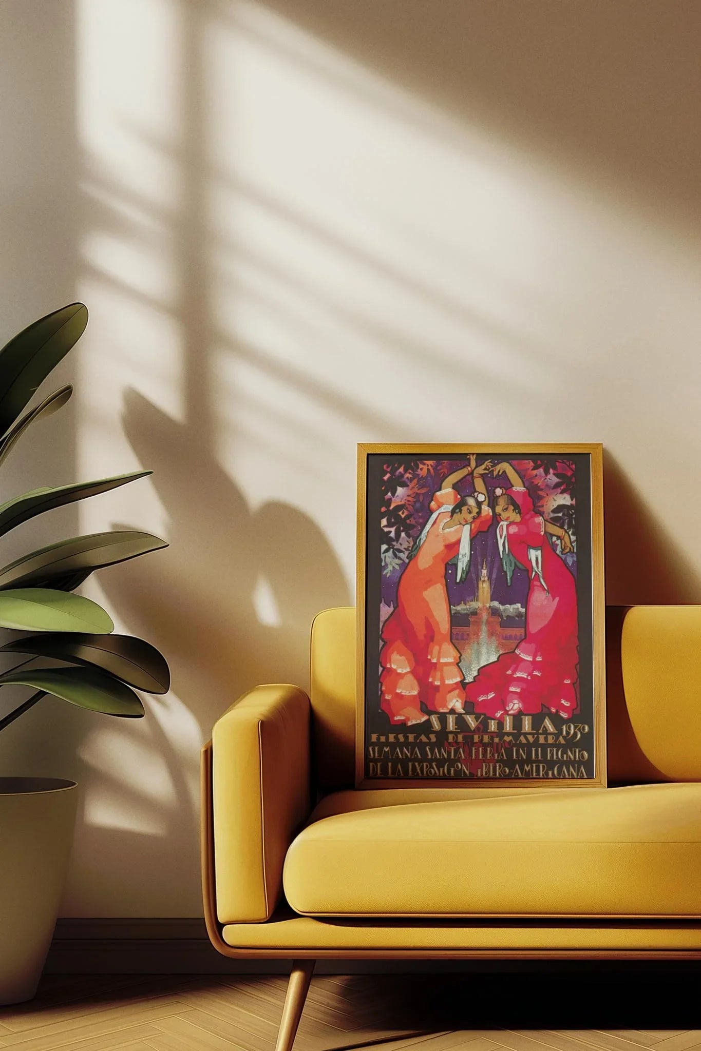 A framed, colorful Mambí poster featuring two dancers leans against the backrest of a yellow sofa. Sunlight streams in, casting plant shadows on the wall and creating a warm, inviting atmosphere.