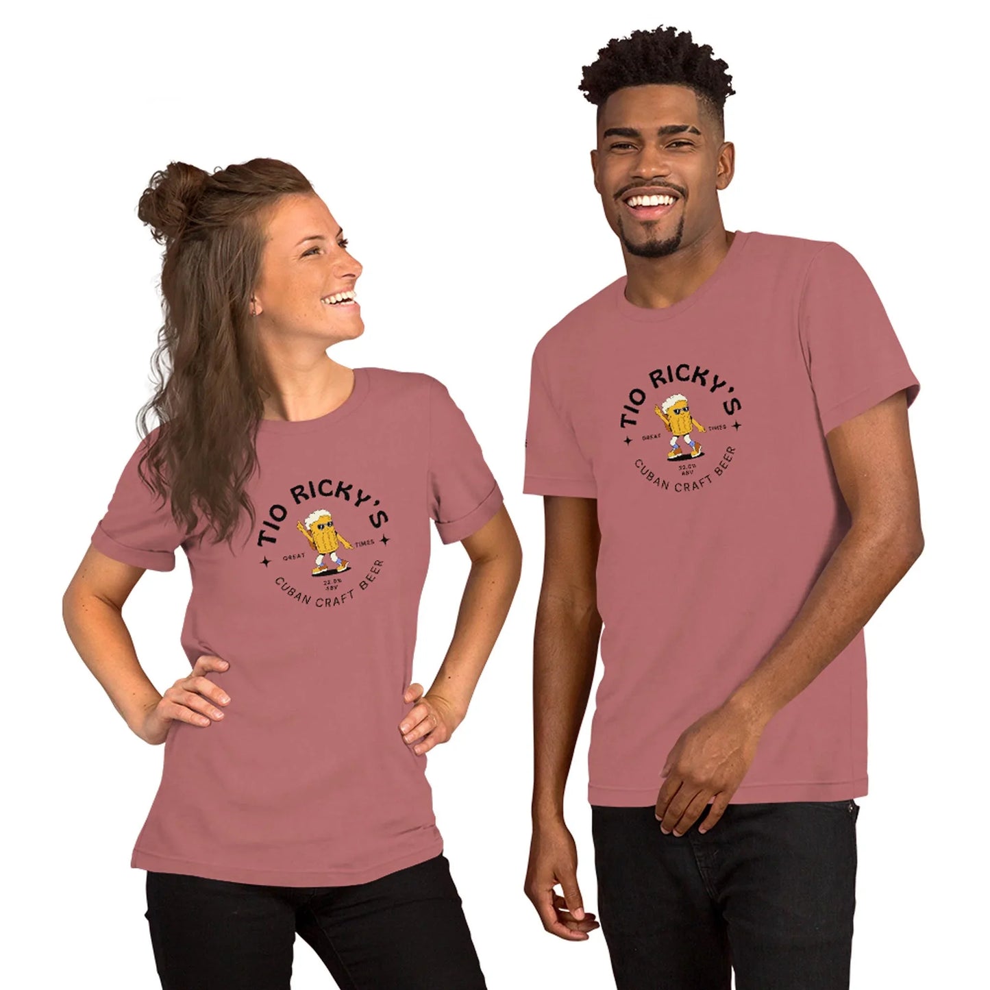 Two people wearing matching dusty pink t-shirts with a Tio Rickys Cuban Craft Beer logo and a subtle Mambí touch. They are smiling and standing side by side, bodies slightly turned toward each other.