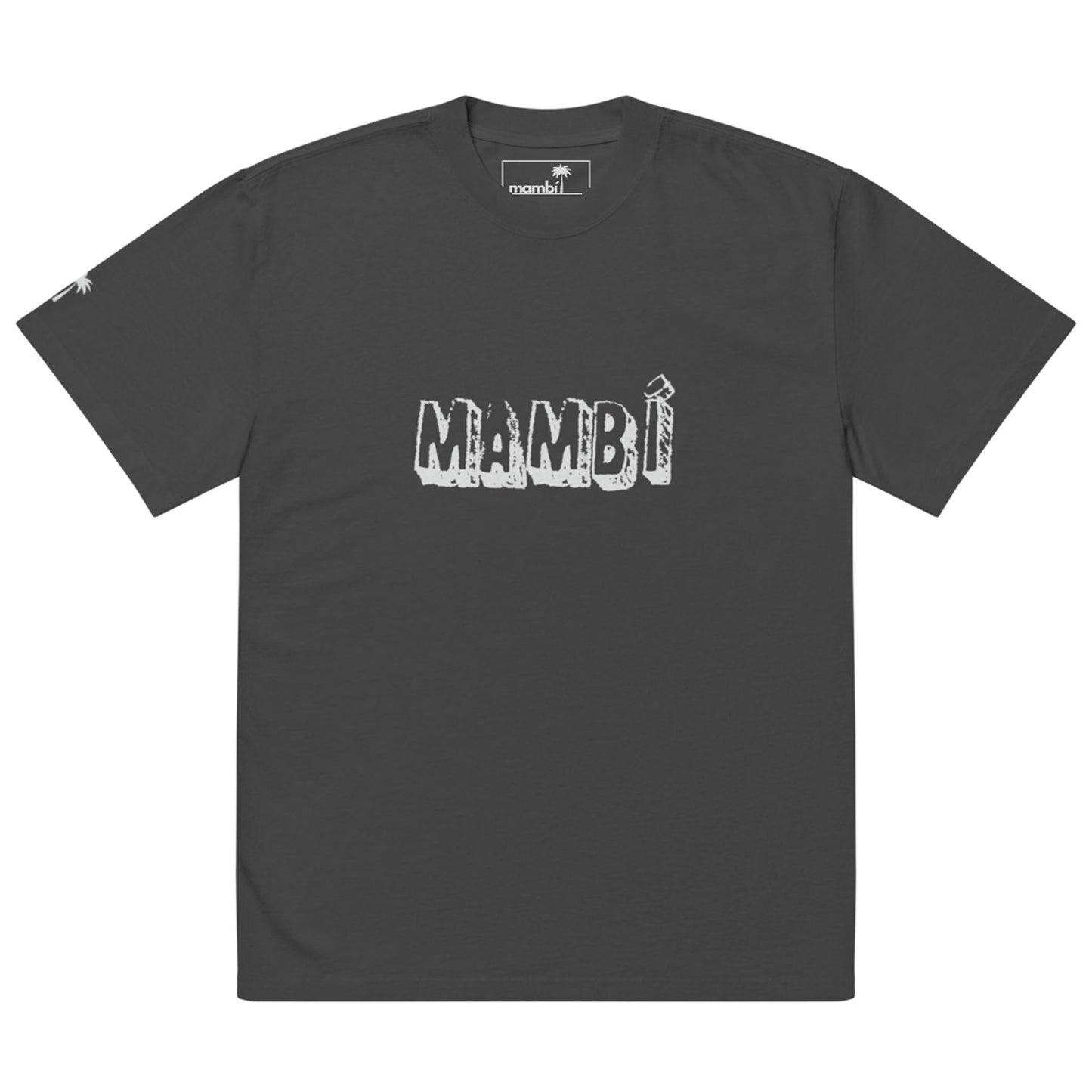 A dark gray t-shirt showcases MAMBÍ in bold, white, textured letters across the chest. A small Mambí logo appears on the inner label, with a subtle graphic detail on the left sleeve.
