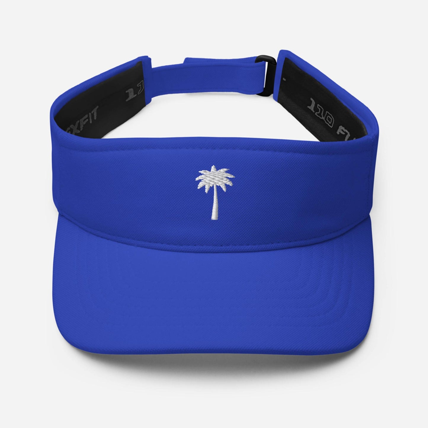 A royal blue Mambí sports visor featuring a small white embroidered palm tree on the front panel, with an adjustable strap at the back.