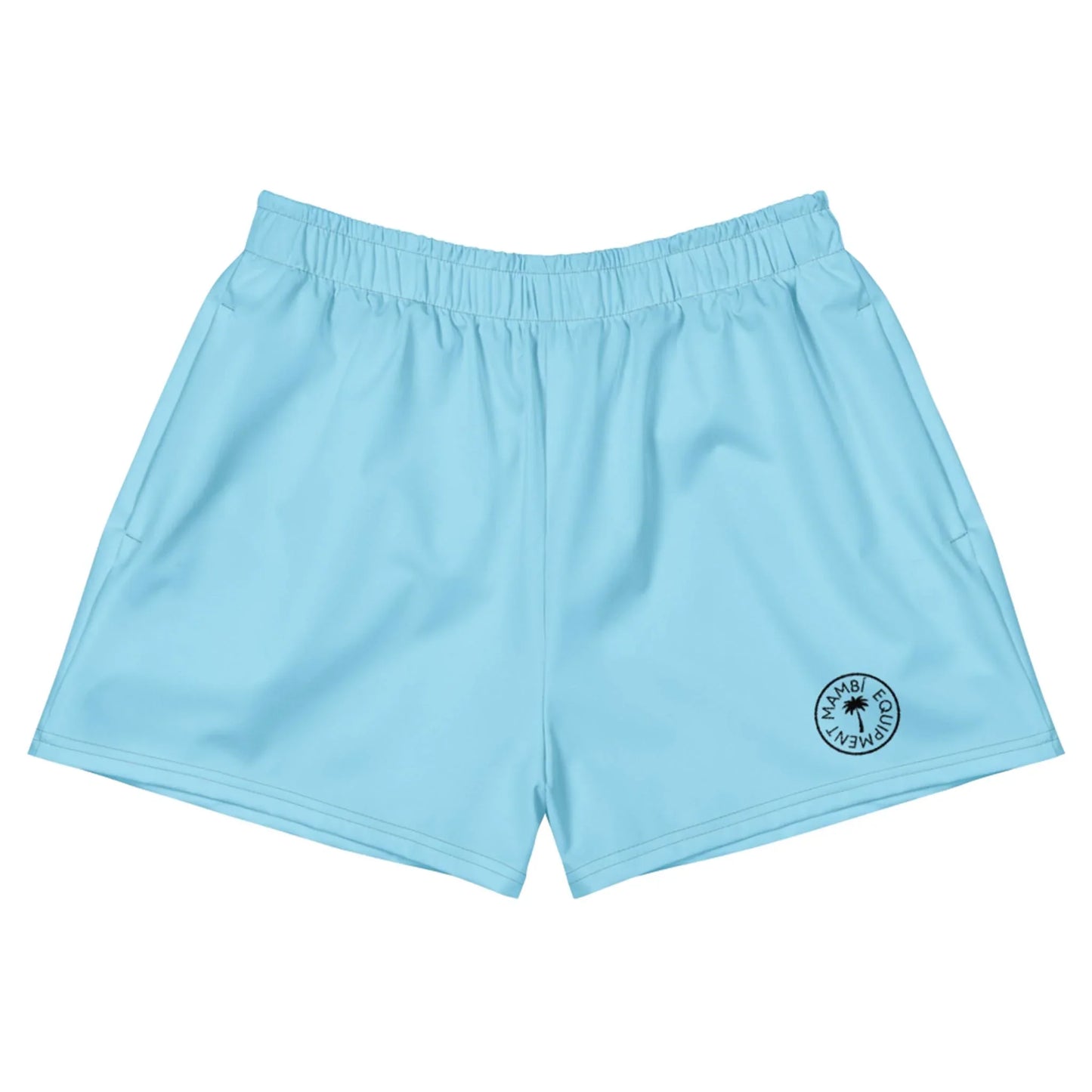 Light blue Mambí athletic shorts with an elastic waistband and a small circular black logo on the lower left leg. The shorts are laid flat against a white background.