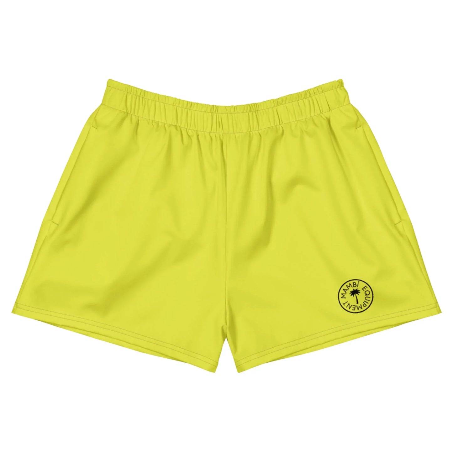 Bright yellow athletic shorts with an elastic waistband and a small circular black Mambí logo on the left leg featuring a star in the center. Shorts are laid flat on a white background.