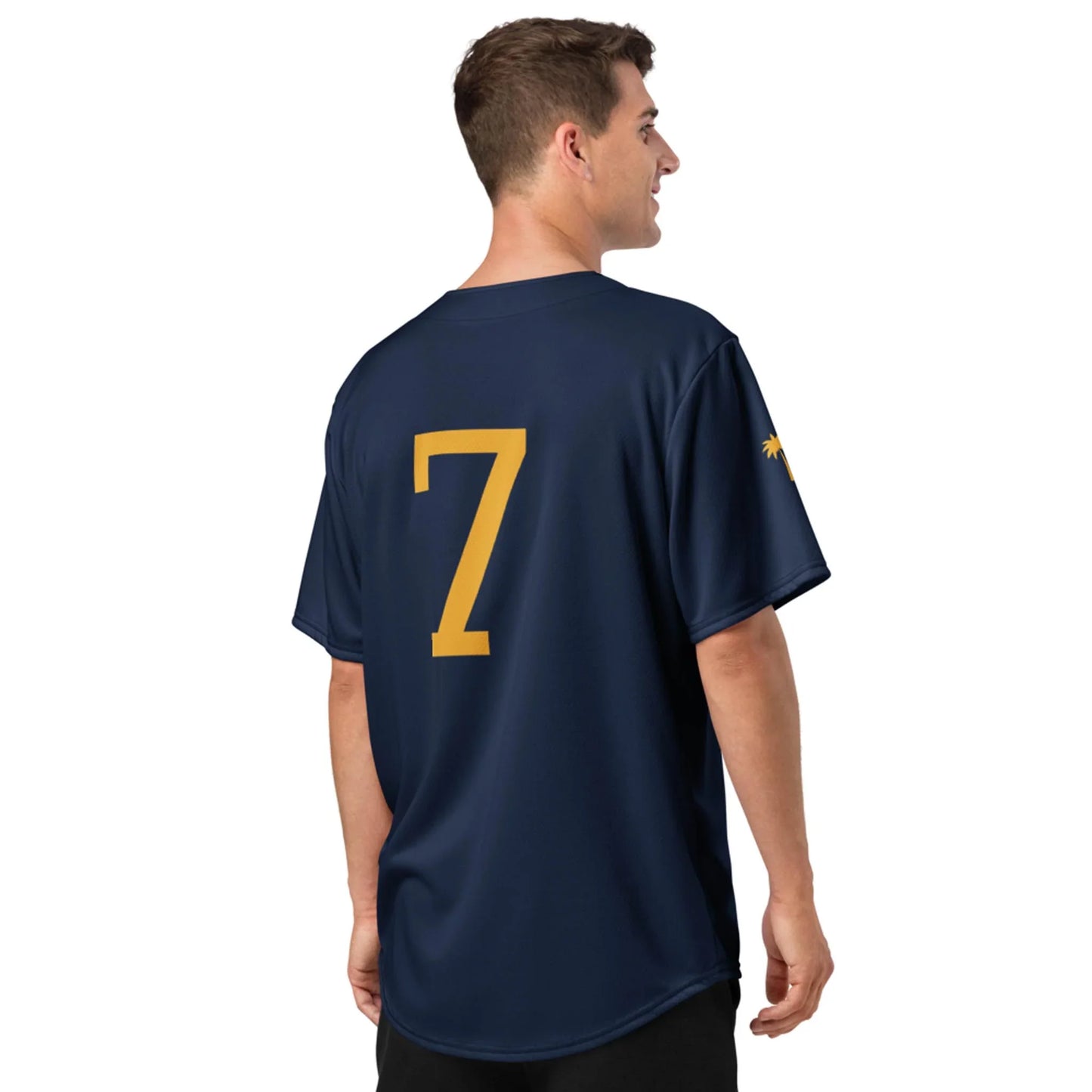 A man faces away, wearing the Printful Zoilo Classic Baseball Jersey in navy blue, unisex fit. The short sleeves display a small yellow graphic and large yellow number 7 on the back for timeless style and comfort.