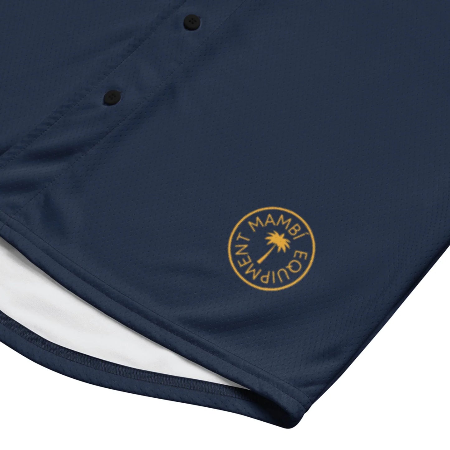 The Zoilo Classic Baseball Jersey by Printful features navy blue fabric, black buttons for a timeless look, and a gold circular MAMBI EQUIPMENT logo near the hem, inspired by vintage baseball jerseys.