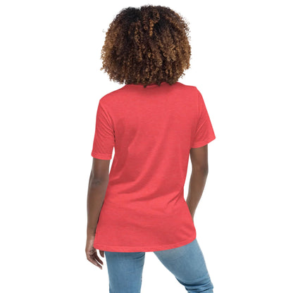 A person with curly hair stands with their back to the camera, wearing the Printful Abigail Relaxed-Fit Logo Tee for women (white logo) and blue jeans against a plain white background.