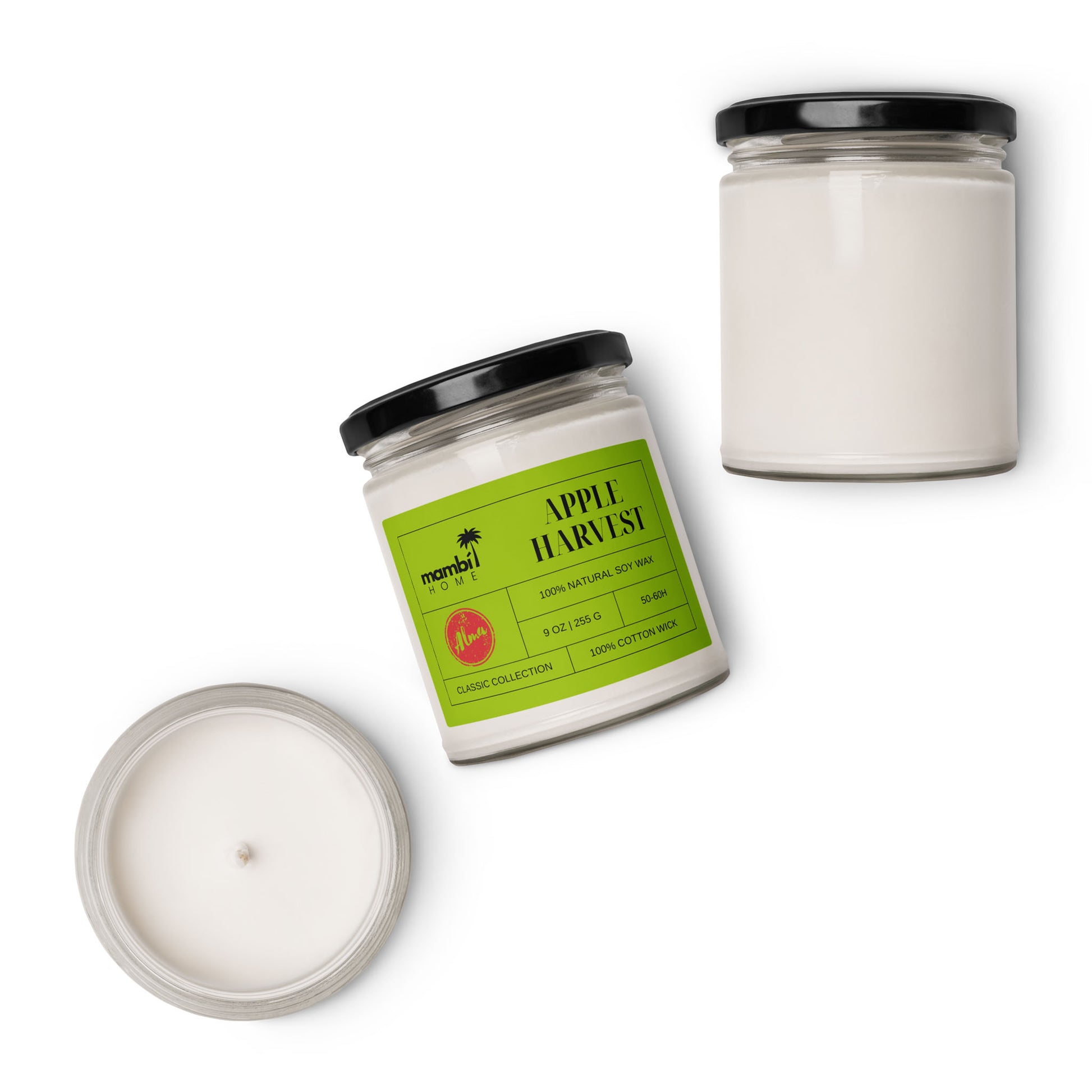 Three white scented soy candles in clear glass jars are displayed against a white background. One jar, labeled Apple Harvest with a green label, stands beside two unlabeled eco-friendly candles—one with its lid on, the other off.