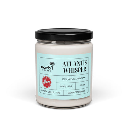 A glass jar candle with a black lid labeled Atlantis Whisper by Mambi Home. This scented soy candle features 100% natural soy wax, 9 oz, 50-60 hours long burn time, classic collection, and a 100% cotton wick.