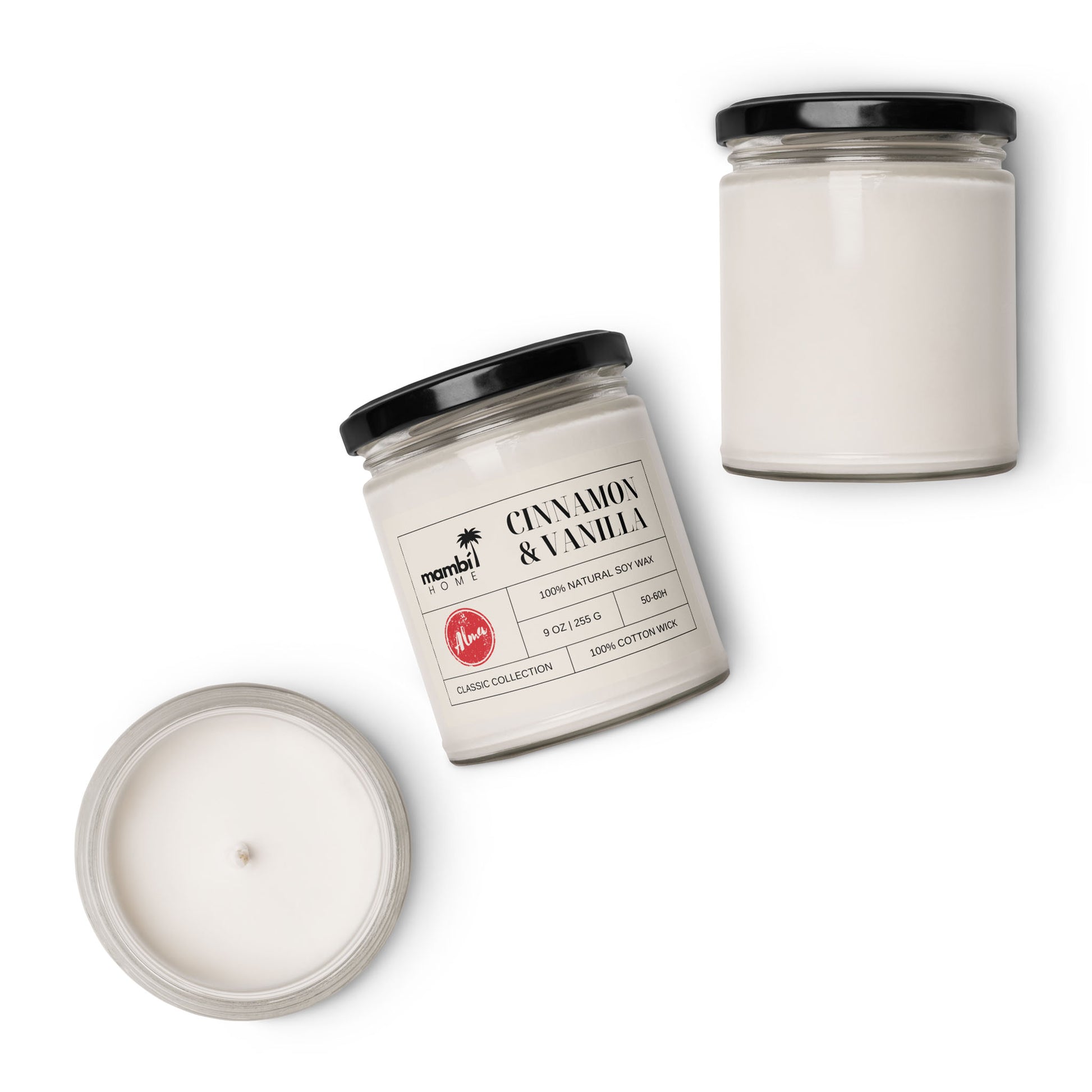 Three glass jars with black lids contain white scented soy candles. One jar is closed, one is open to reveal the candle inside, and one is tilted, displaying a label that reads Cinnamon & Vanilla.