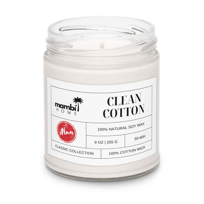 A glass jar candle labeled mambi HOME CLEAN COTTON features 100% natural soy wax, a 100% cotton wick, and a fresh scent. Part of the CLASSIC COLLECTION, these eco-friendly candles offer a 50-60 hour burn time in a 9 oz (255 g) size.