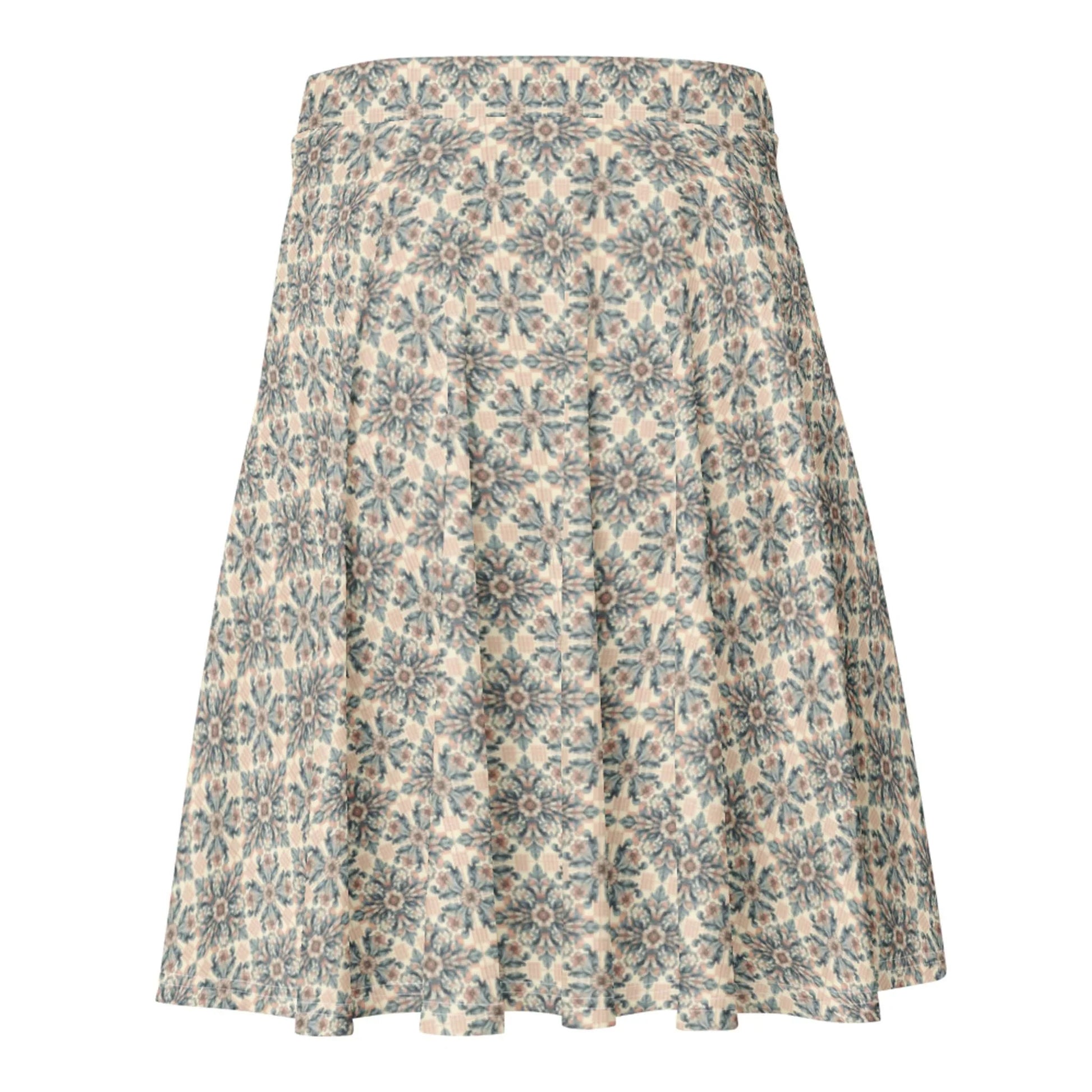 A knee-length A-line skirt featuring an intricate blue and grey floral geometric pattern on a beige background. The Mambí skirt has a fitted waistband and flows outward toward the hem.