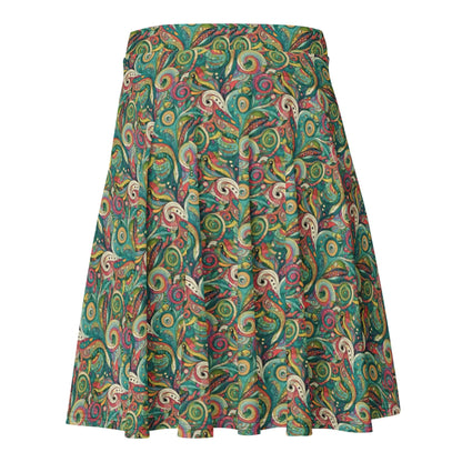 The Barbarita Skater Skirt by Printful is knee-length, features a flared silhouette and elastic waistband, and showcases a vibrant paisley print in green, yellow, red, and blue against a white background.