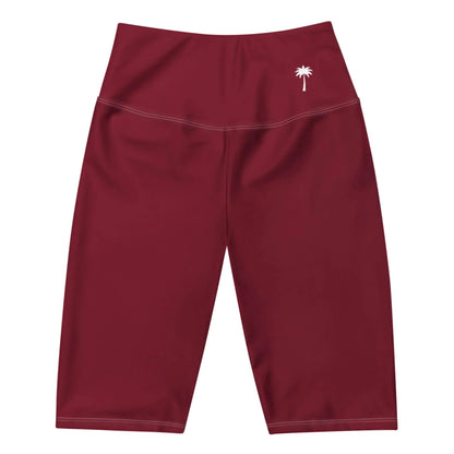 High-waisted, maroon-colored Mambí athletic shorts with white stitching and a small white palm tree logo on the left hip, displayed on a white background.