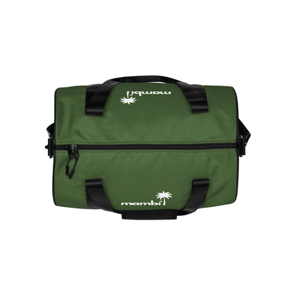 A green Mambí duffel bag with black straps and zipper, featuring a white palm tree logo and the word mambí printed on the top and side, photographed on a white background.