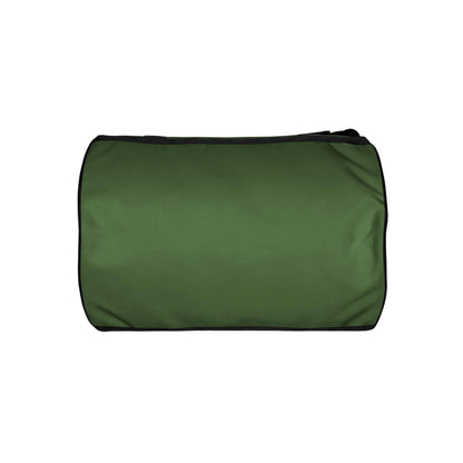 A rectangular, green Mambí duffel bag with black trim is shown against a white background. The bag is viewed from the side, displaying a smooth surface without visible handles or logos.