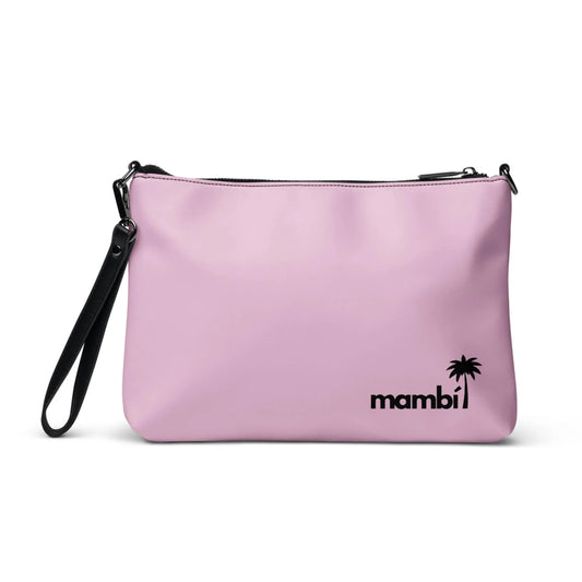 The Blake Crossbody Bag by Printful is a light pink faux leather clutch with a black wrist strap, top zipper, the word mambi, and a small black palm tree graphic in the lower right corner for a chic look.
