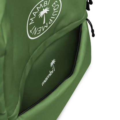 Close-up of the Boulevard East All-Purpose Backpack by Printful, featuring a partially open front pocket with a white mambi logo and palm tree graphic. The top showcases a circular Mambi Equipment logo; includes a hidden back pocket for security.