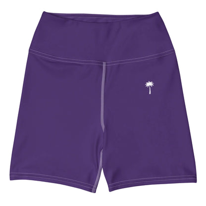 The Brickell Yoga Shorts by Printful are high-waisted, purple, and feature a small white palm tree on the left leg, visible white seams, and four-way stretch for comfort.