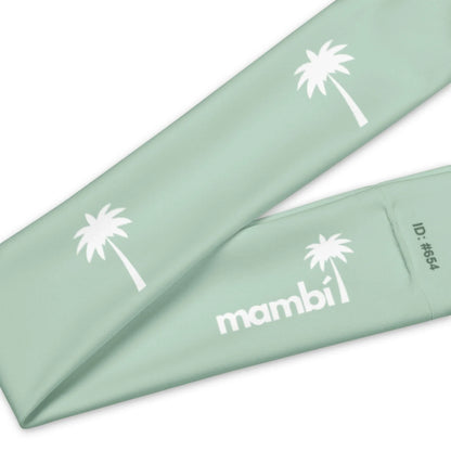 A mint green fabric band featuring white palm tree graphics, Mambí in bold white letters, and ID number #654.