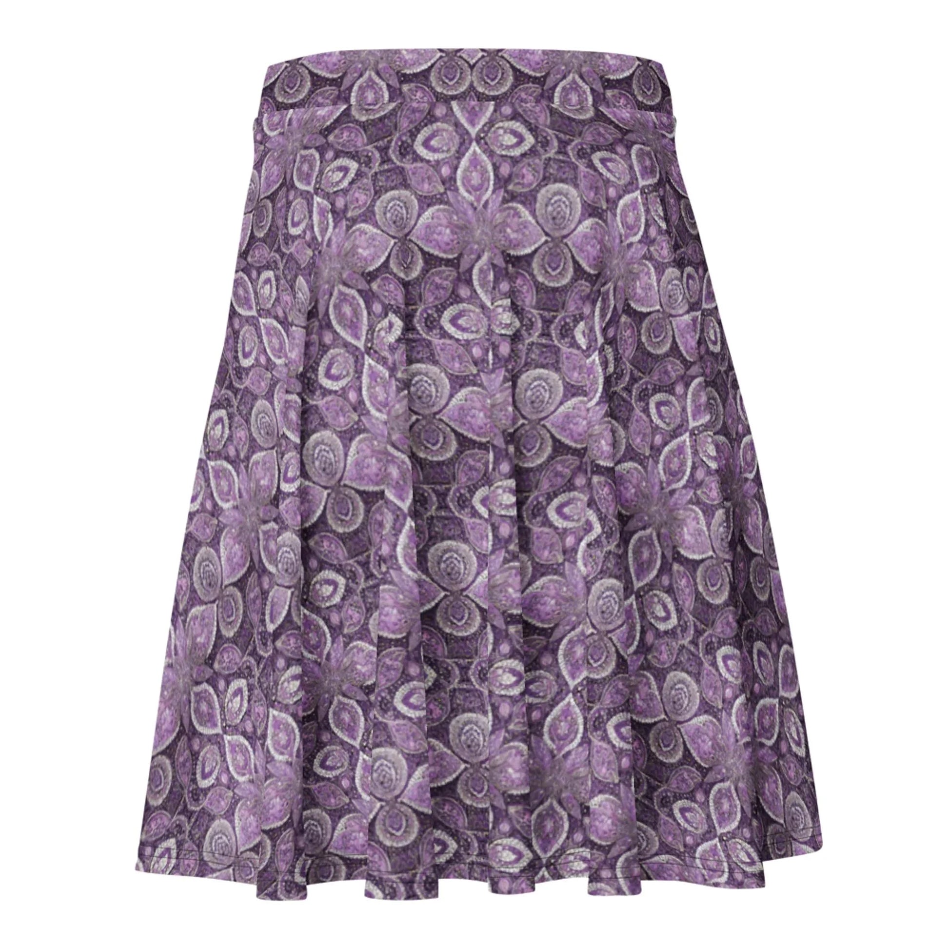 The Candelaria Skater Skirt by Printful is a flared, knee-length skirt with a purple and white floral paisley pattern, flowy design, and no visible waistband or fastenings for a flattering silhouette.